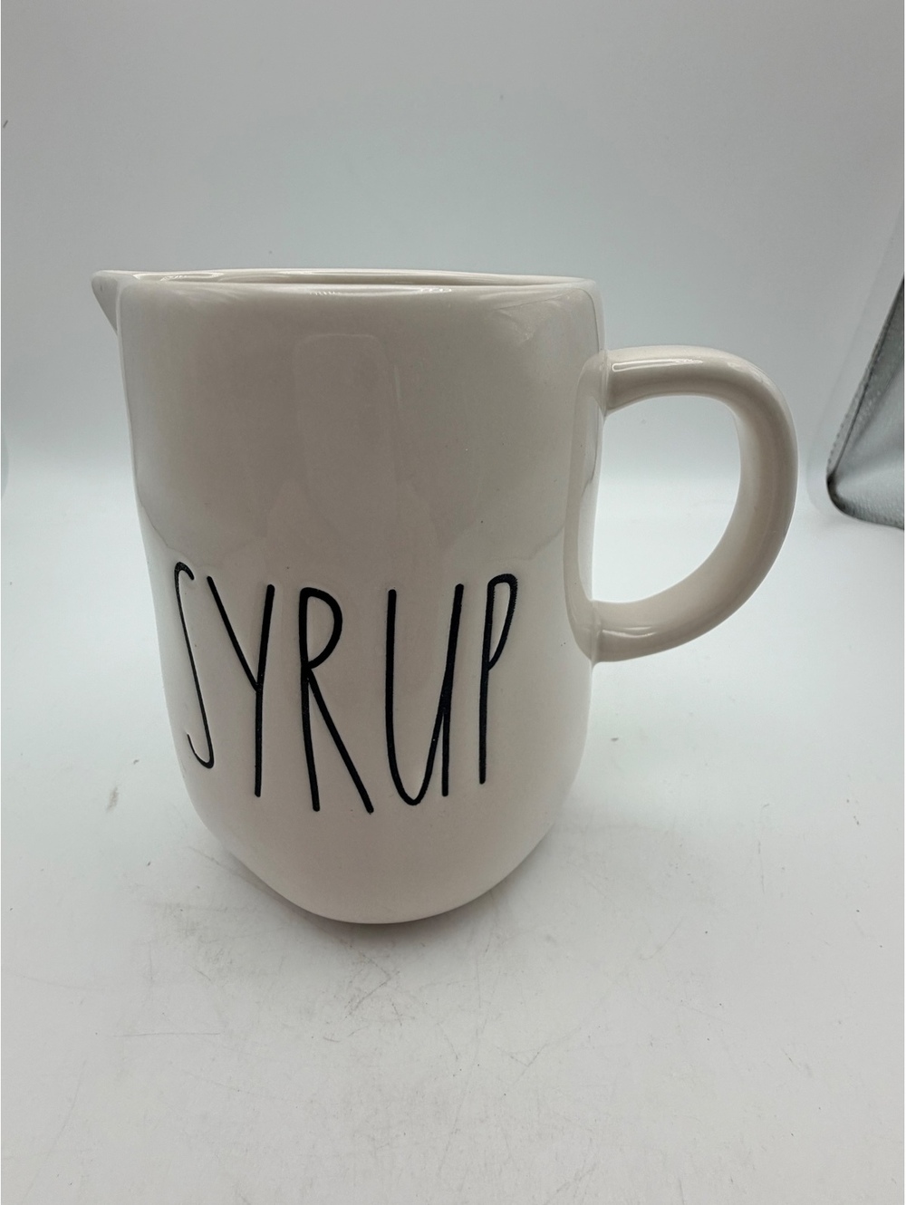 Rae Dunn white ceramic syrup pitcher.with handle. In like new condition